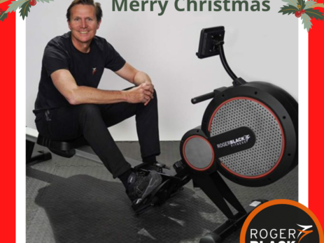 Roger Black on a rower with festive decorations